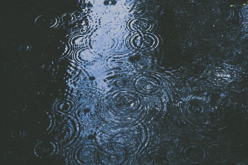 rain drops splashing on a wet surface
